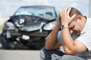 Man holding his head in his hands after an automobile accident